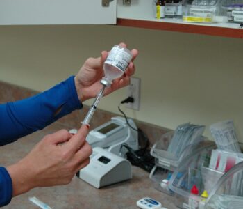 Photo of nurse filling syringe