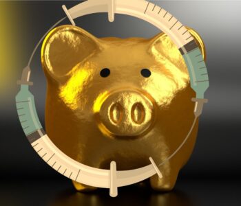 Golden piggy bank with syringes surrounding